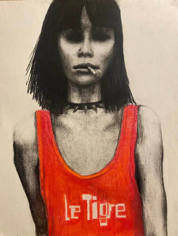 Portrait of a dark-haired woman wearing a red Le Tigre top