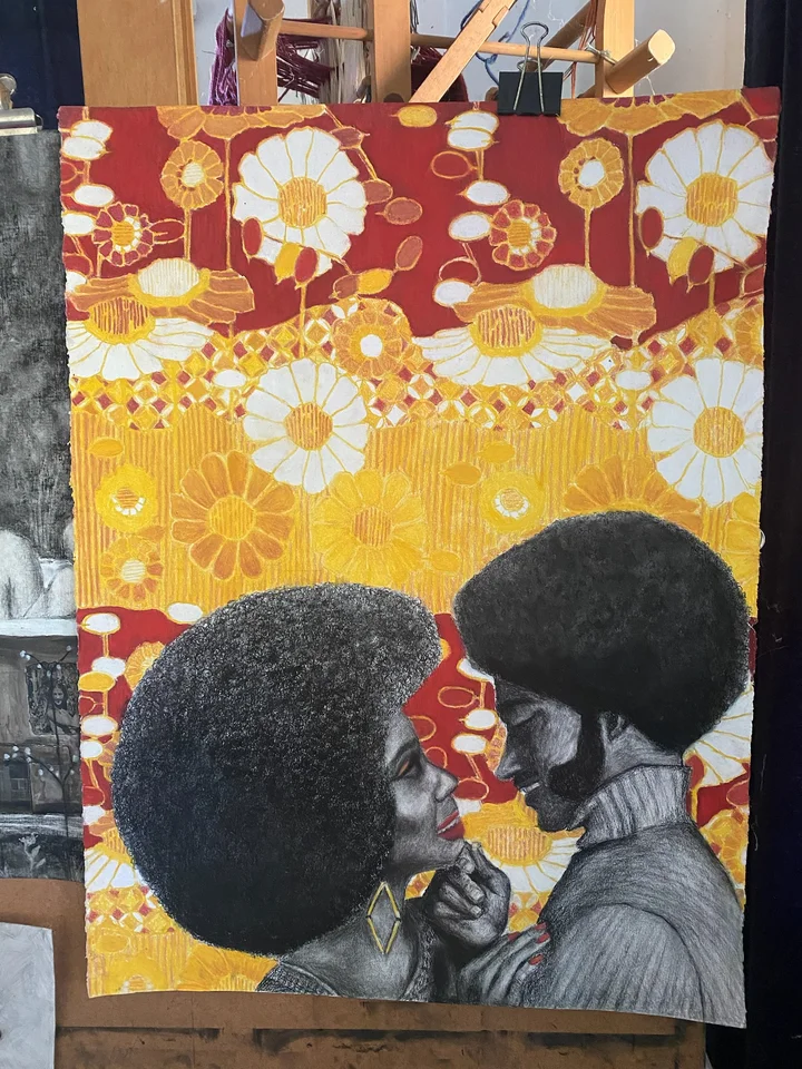 Two dark-haired figures beneath a yellow floral pattern