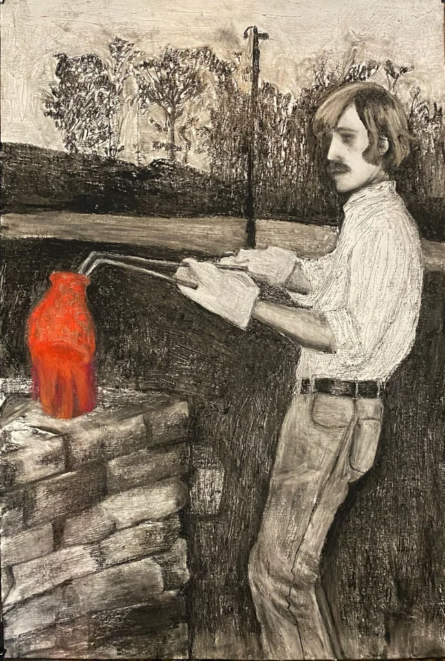 Ted Hillyer standing beside a raku kiln with a glowing red pot